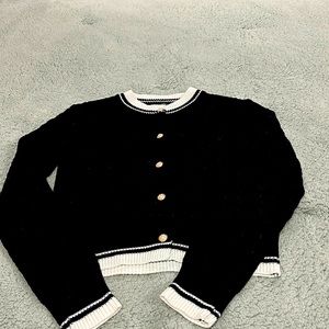 Black and white cardigan with pearl buttons.  Excellent condition. Size small
